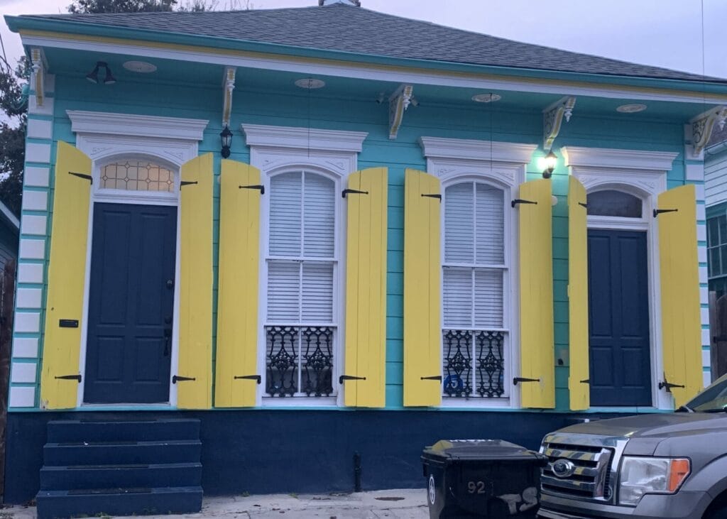 Vibrant and colorful homes lining the streets of New Orleans, showcasing a kaleidoscope of hues and tones. A house of dark blue and sunny yellow looks great!