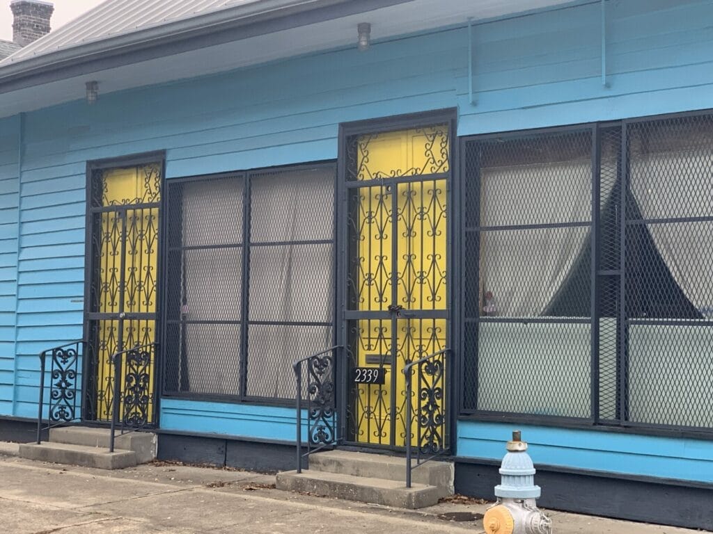 Vibrant and colorful homes lining the streets of New Orleans, showcasing a kaleidoscope of hues and tones. Blue walls and high ceiling bright yellow doors sure stands out.