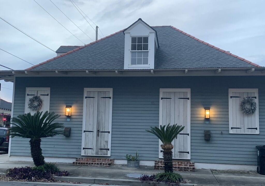 Vibrant and colorful homes lining the streets of New Orleans, showcasing a kaleidoscope of hues and tones. Grey and white tone duplex.