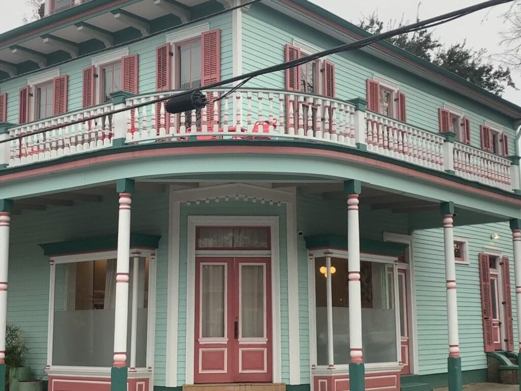 Vibrant and colorful homes lining the streets of New Orleans, showcasing a kaleidoscope of hues and tones. Mint 2 level with red doors.