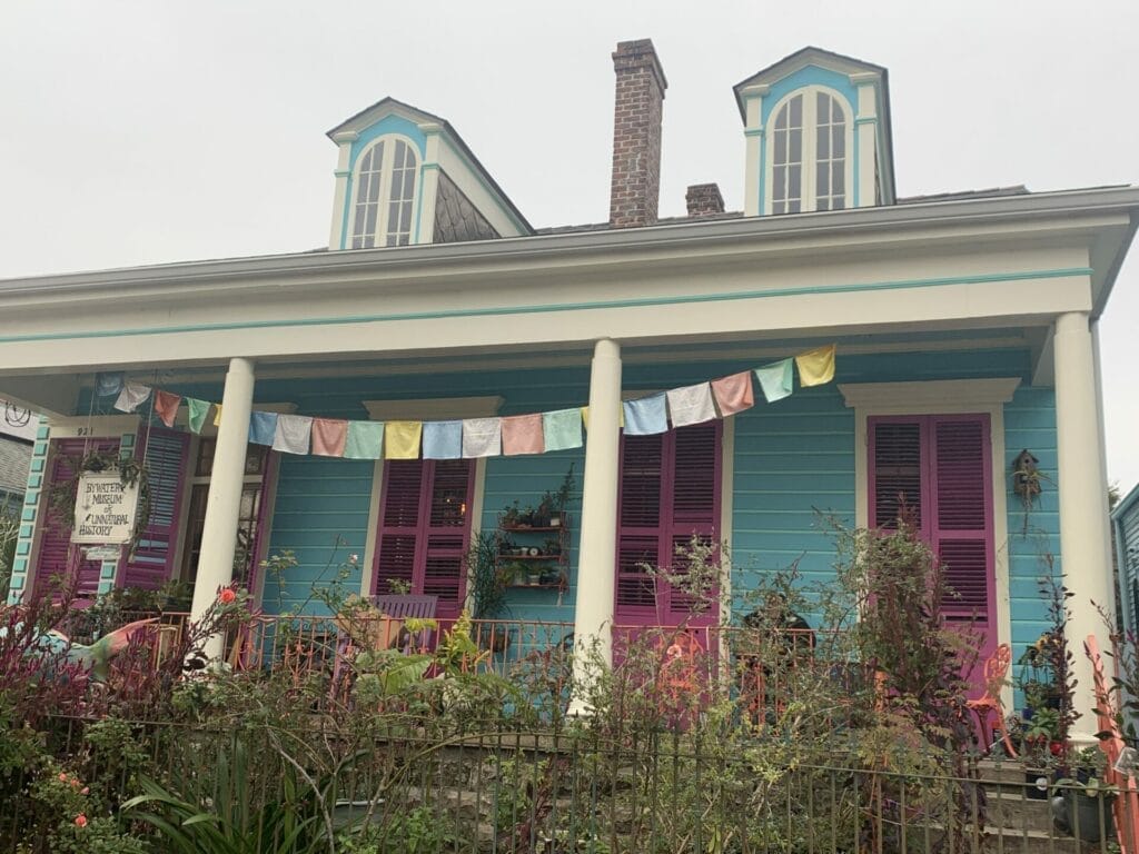 Vibrant and colorful homes lining the streets of New Orleans, showcasing a kaleidoscope of hues and tones. Teal inviting home.