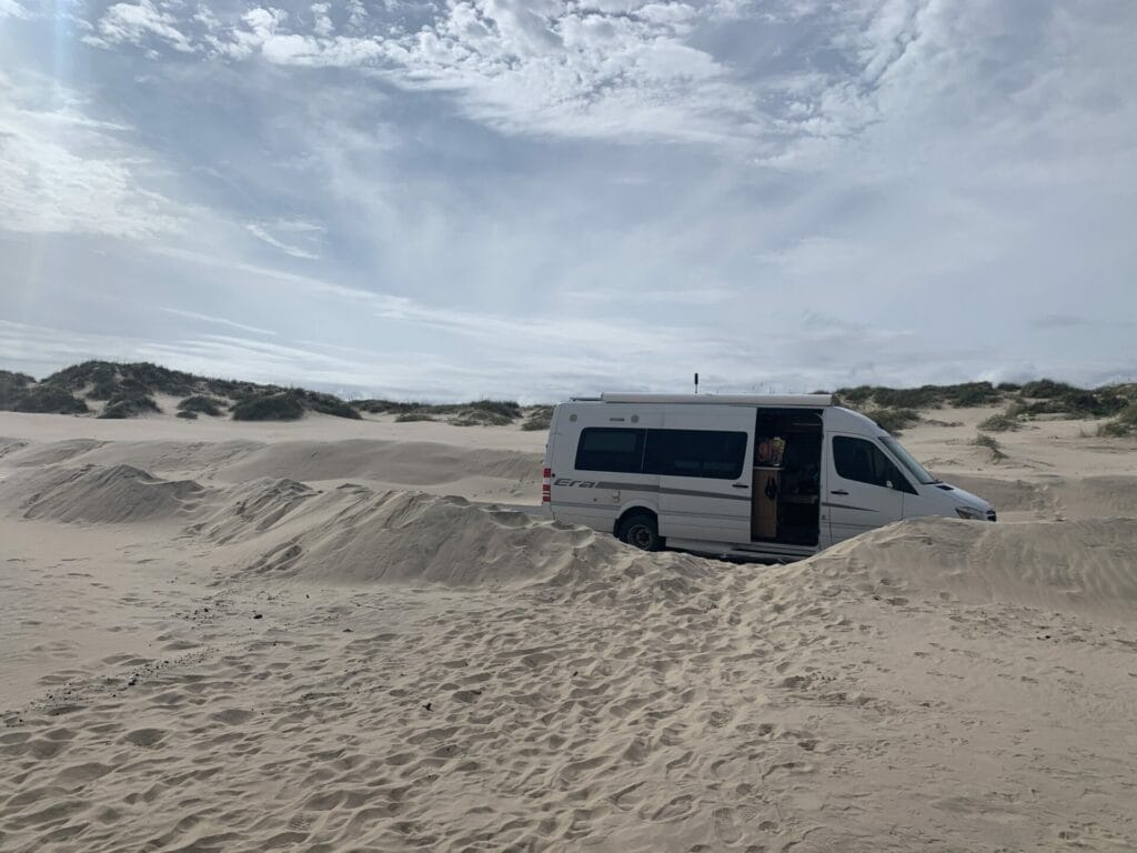 Converted van parked in the sand