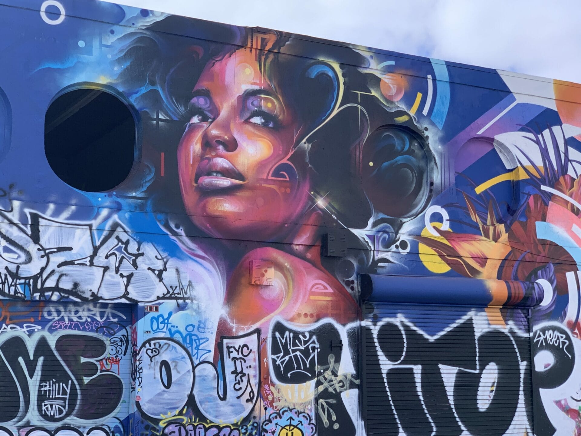 Vibrant street mural in Wynwood, Florida, showcasing colorful artwork on urban walls. They are so well done on such a big canvas!