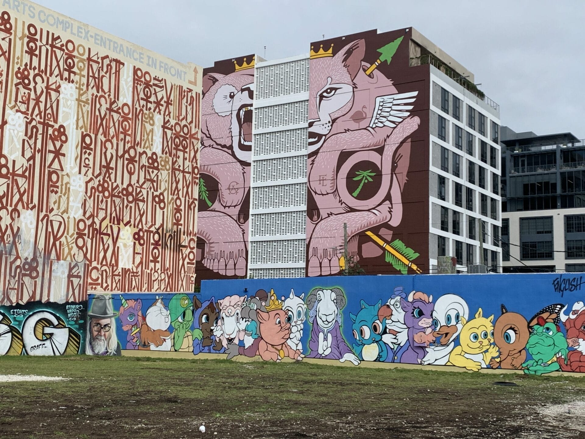 Vibrant street mural in Wynwood, Florida, showcasing colorful artwork on urban walls. Multiple murals on multiple buildings. Layers of colorful paintings.