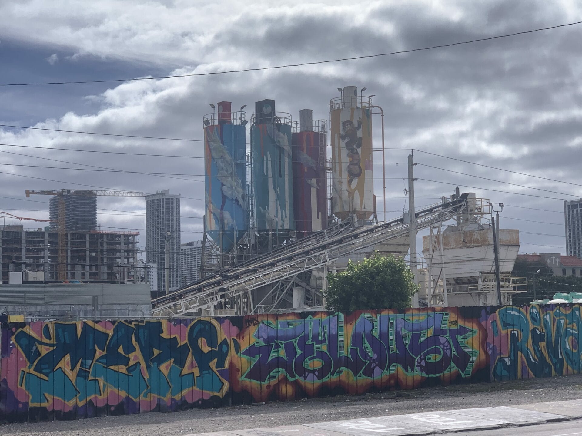 Vibrant street mural in Wynwood, Florida, showcasing colorful artwork on urban walls. Even industrial plants are covered with colorful murals.