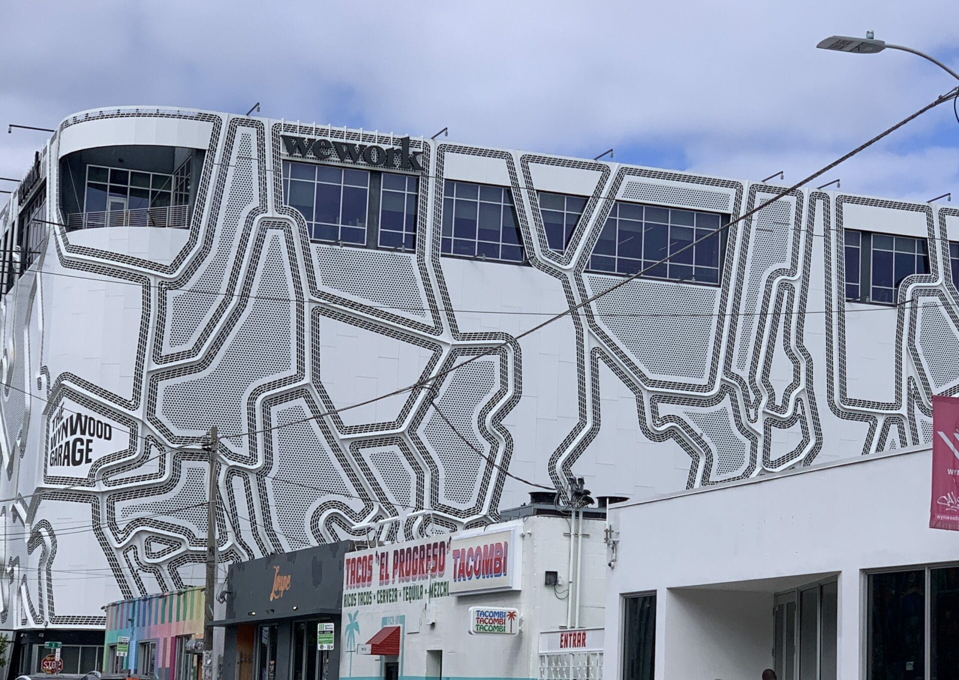 Vibrant street mural in Wynwood, Florida, showcasing colorful artwork on urban walls. Simple black and white.