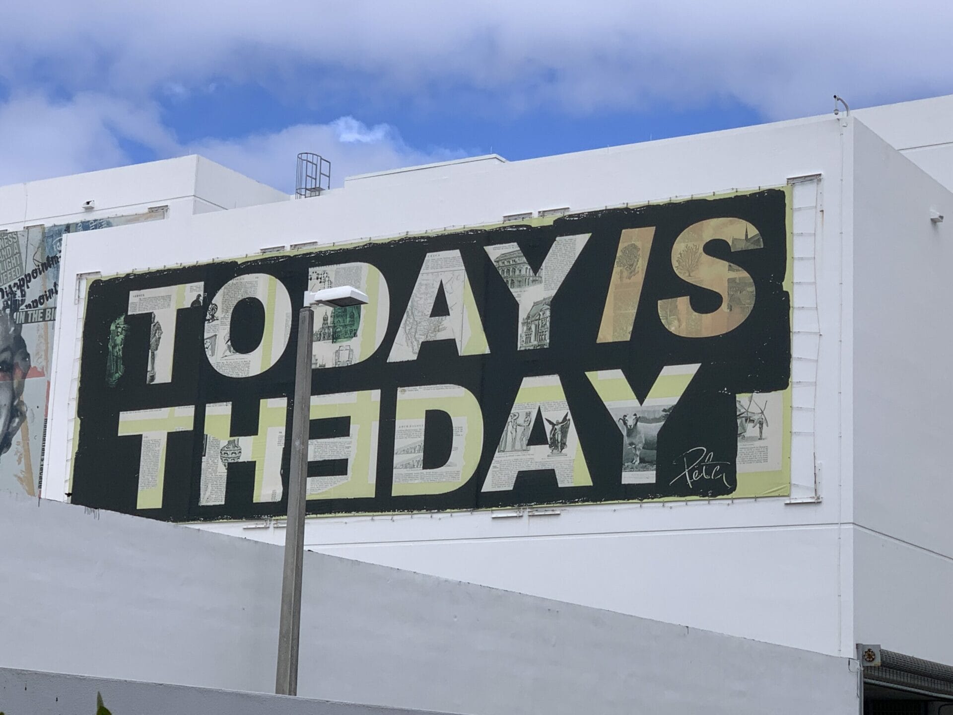 Vibrant street mural in Wynwood, Florida, showcasing colorful artwork on urban walls. Positive quote-Today is the Day.
