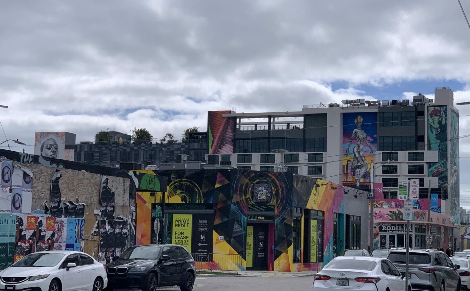 Vibrant street mural in Wynwood, Florida, showcasing colorful artwork on urban walls. Layers of murals.