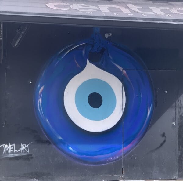 Vibrant street mural in Wynwood, Florida, showcasing colorful artwork on urban walls. Beautiful glass evil eye on the side of the building.