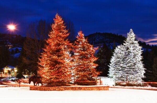 Christmas tres lid up in the snowy Aspen, Colorado, an eco-friendly town to celebrate eco-friendly Christmas.