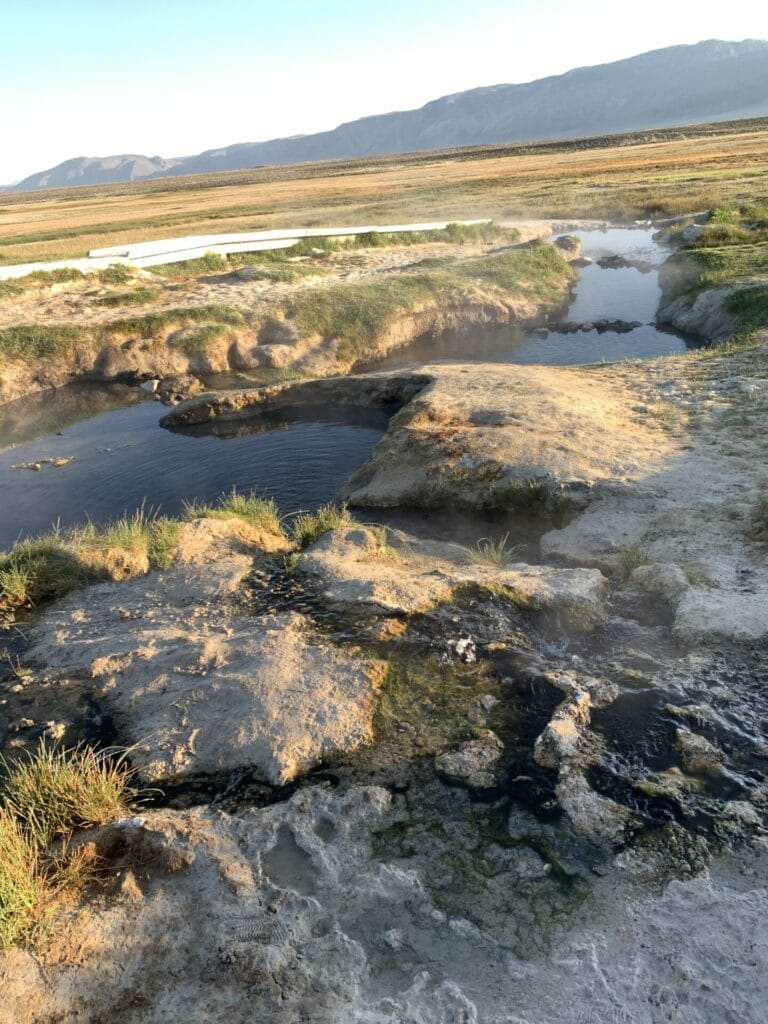 Different pools are blocked off by rocks to create different depth and temperature at Wild Willy's Hot Springs in Eastern Sierra, California.