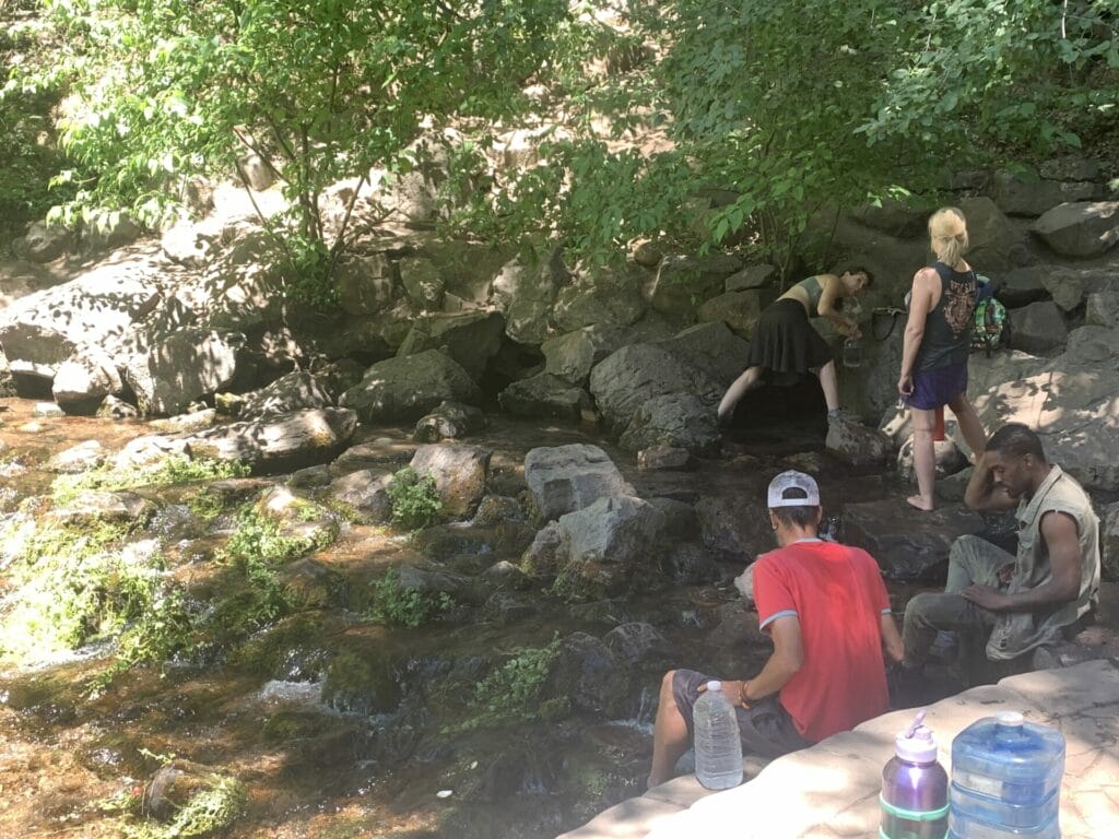 People catching fresh spring water at the source of Sacramental River, also known as the Big Springs, is a Northern California natural cold springs.