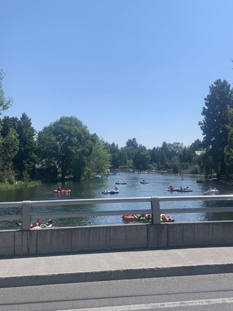 Deschutes River tubing through Bend, Oregon is a wonderful river to float down. A few floaters are shown on the natural lazy river.