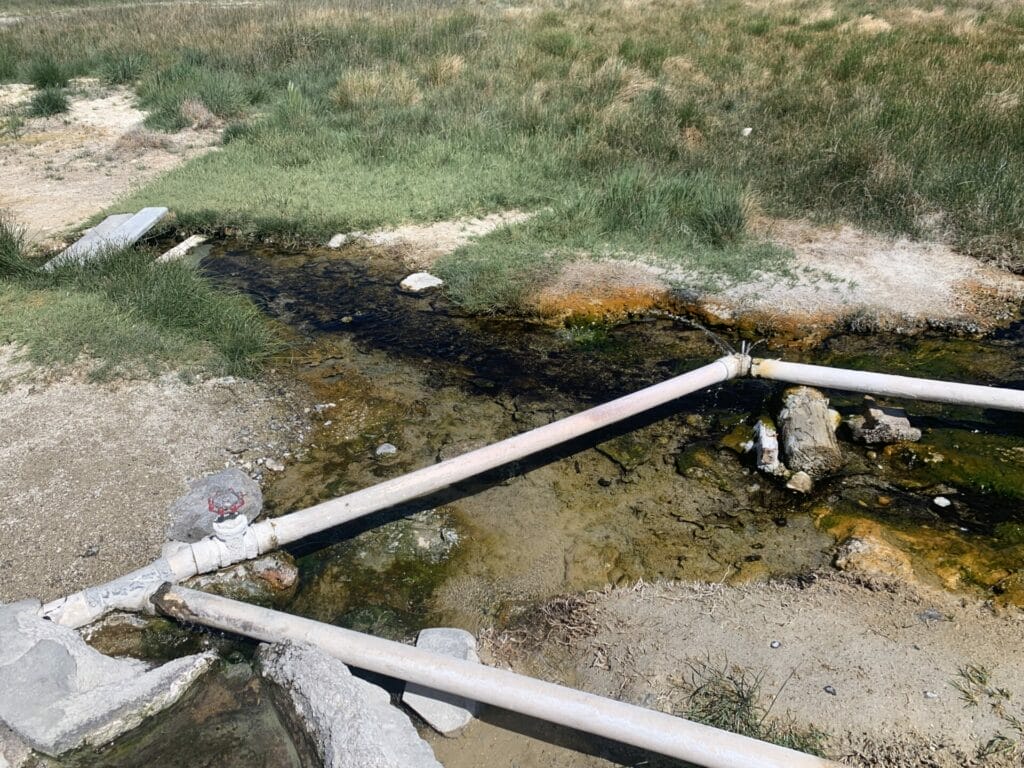Picture of the pipe with gate valve to control the flow of the thermal water at the Hilltop Hot Springs.