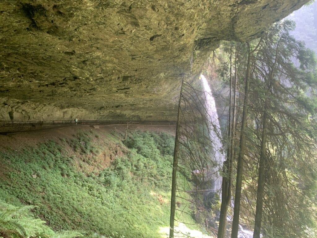 North Falls from Silver Falls State Park in Oregon has a very deep rock ledge for people to walk behind.