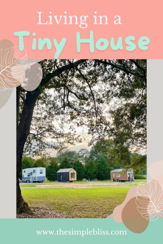 Three tiny homes seen through trees with the words "Living in a Tiny House".