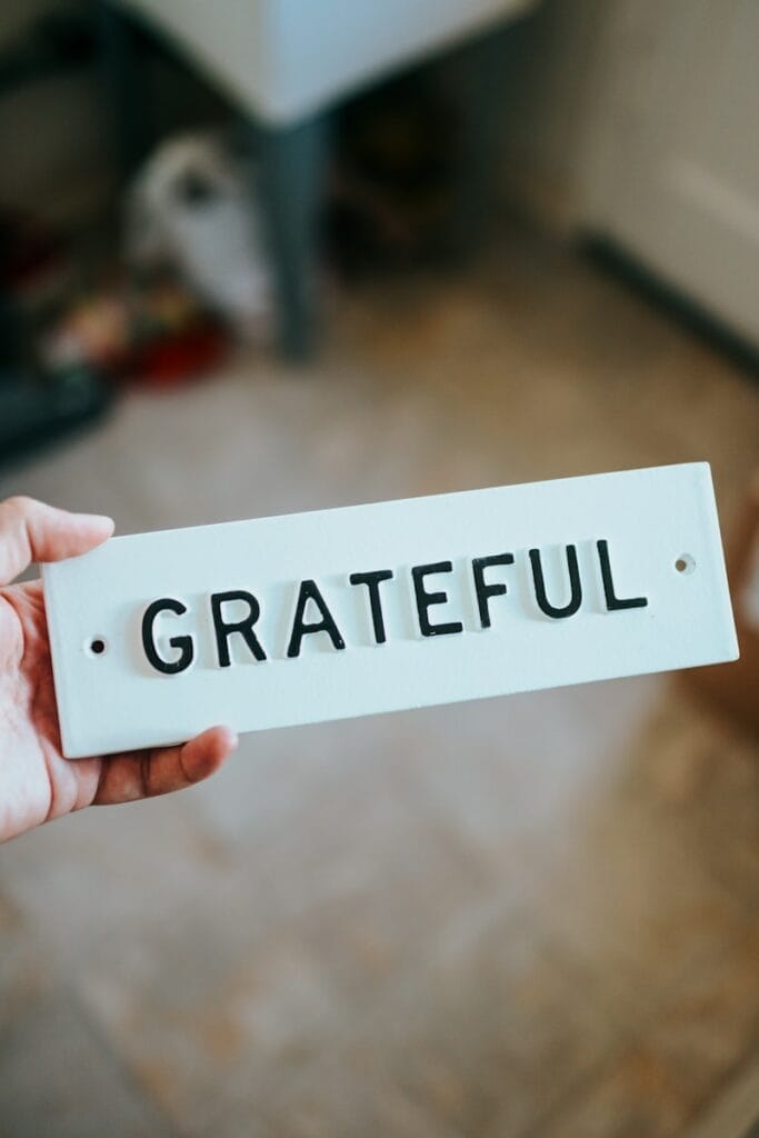 person holding white and black Grateful board.