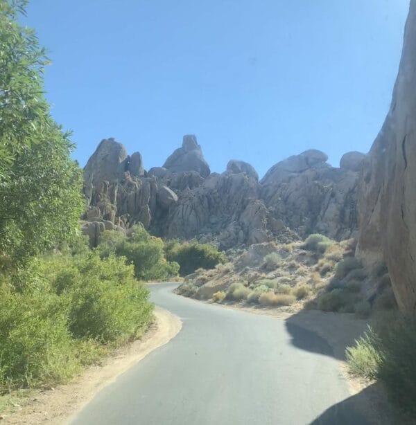 Photo during the drive through Alabama Hills with boulders and rock formations along the curvy road.