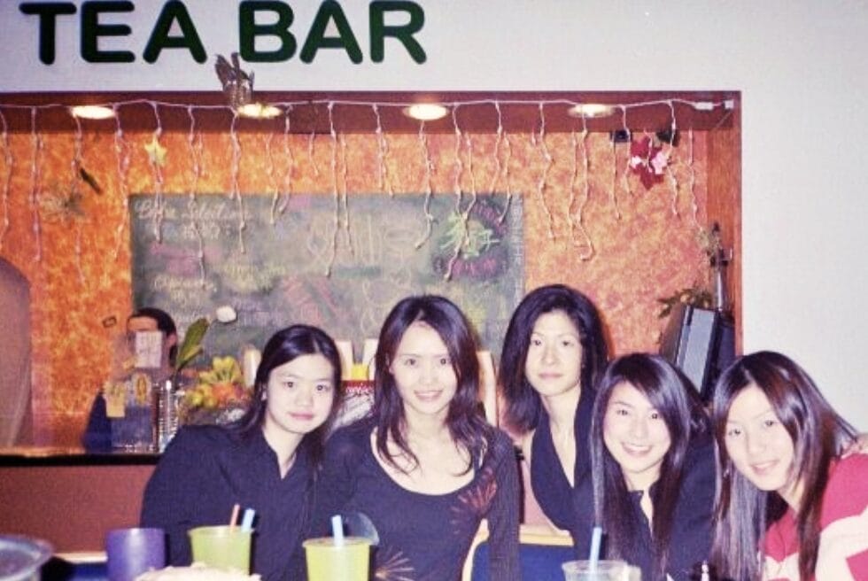 Group of ladies lined up for the photo in front of a store with the words Tea Bar as the sign.