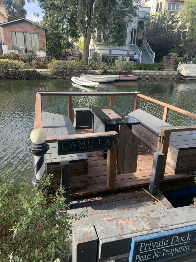 Private morning dock with fire pit and benches on the waterway of Venice Beach Canals.