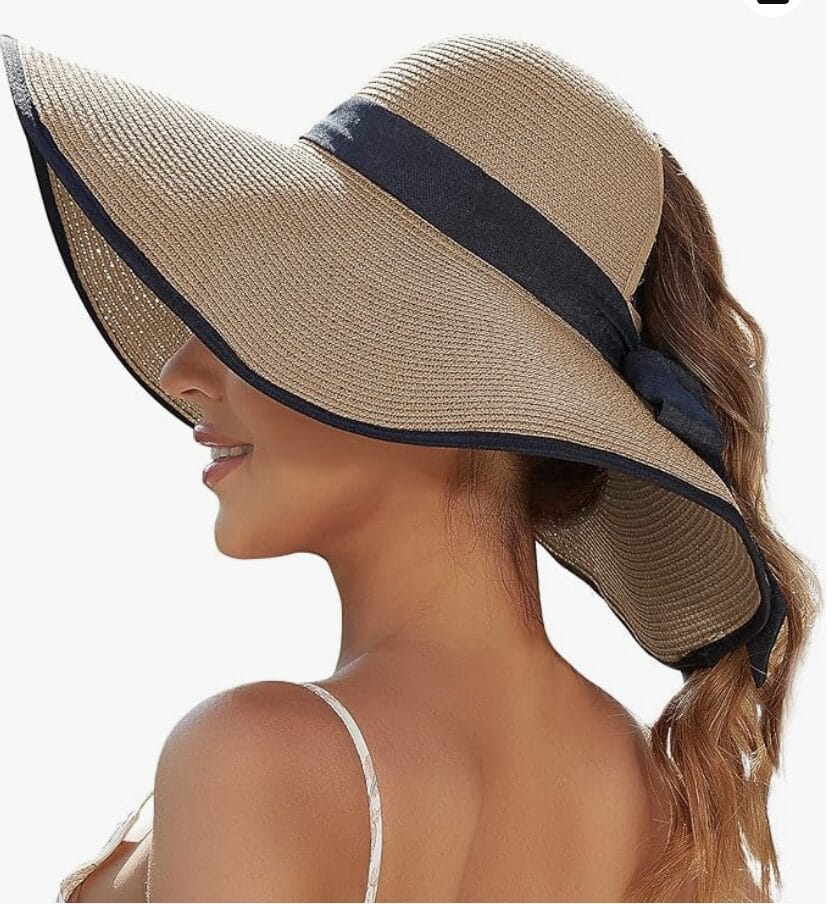 Lady with ponytail wearing a wide rim straw hat that allows the ponytail to come through.