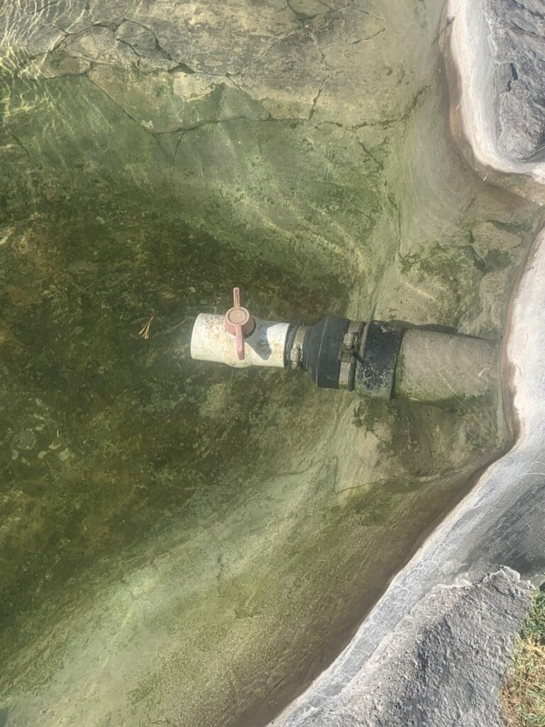 Adjustable valve in a body of water in Siphon Hot Springs California.