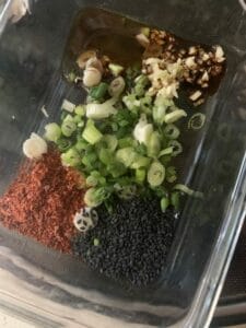 Ingredients in a container to make Korean spicy soybean sprouts side dish.