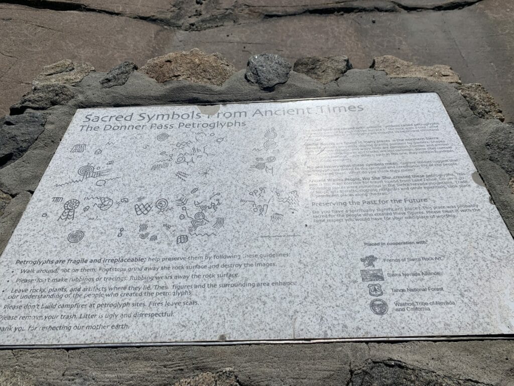 A plaque next to petroglyphs in Donner Pass showcasing petroglyphs from the natives 1500-4000 years ago.