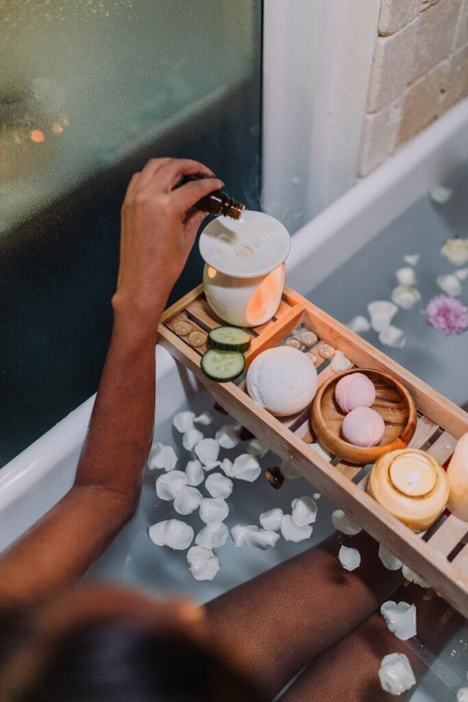A soothing spa bath scene with oil, candles, and flower petals for ultimate relaxation. Aromatherapy is a great stress reliever.