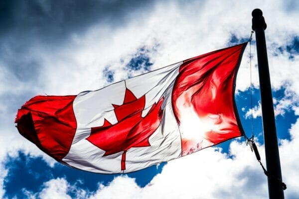 red and white flag under blue sky during daytime. Best Canadian City to Visit!